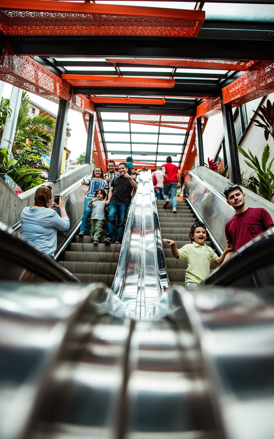 Families riding the orange escalators of Comuna 13 in Medellín