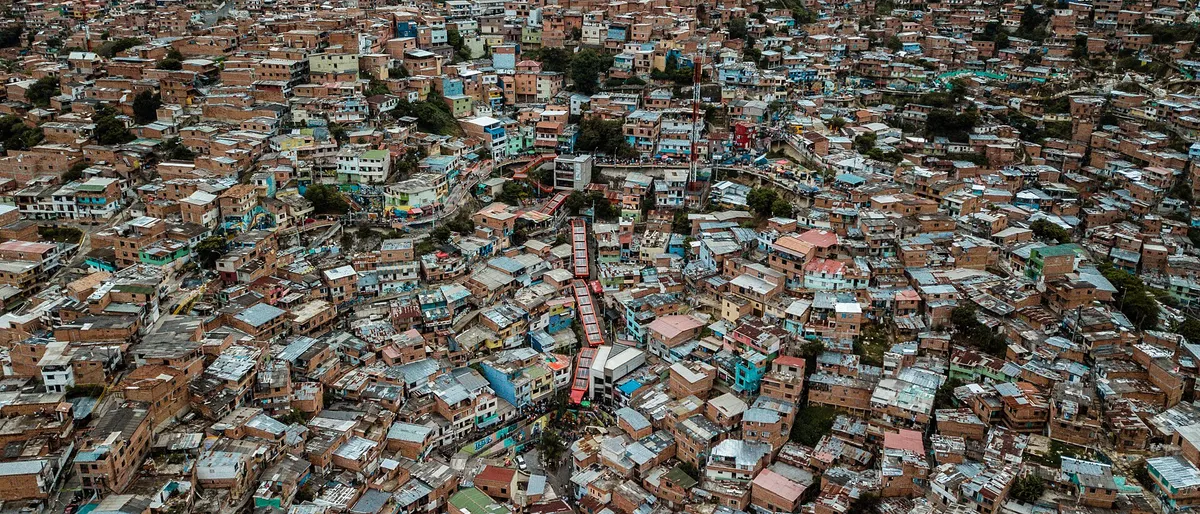 Aerial view of Medellín’s dense hillside neighborhoods at dusk