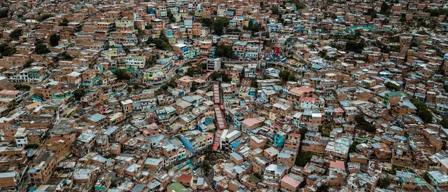 Aerial view of Medellín’s dense hillside neighborhoods at dusk